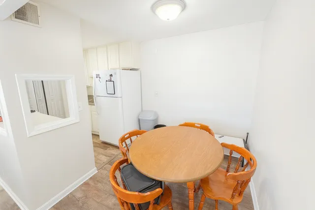 a view of a room with wooden floor and entryway