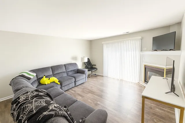a living room with furniture fireplace and flat screen tv