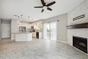 a view of kitchen with refrigerator stove top oven and cabinets