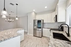 a kitchen with refrigerator and microwave