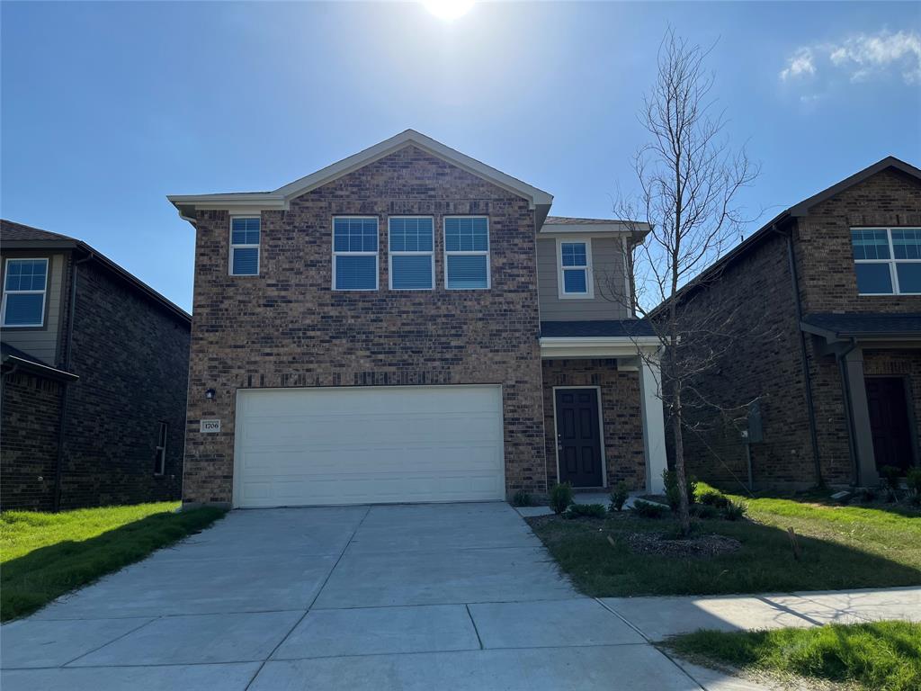 1706 Washington Street Princeton, TX 75407 - Photo 1 of 19 a front view of a house with a yard and garage
