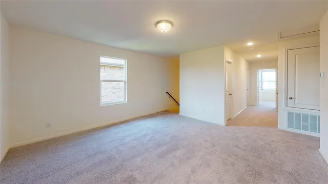 an empty room with windows and entrance