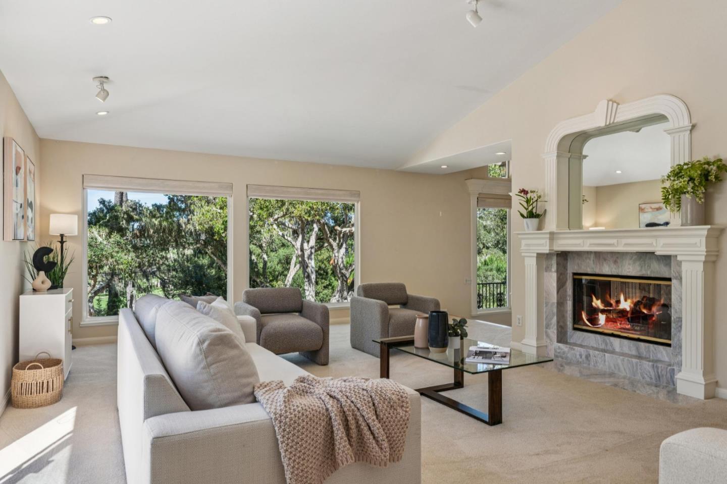 2905 Bird Rock Road Pebble Beach, CA 93953 - Photo 8 of 33 a living room with furniture a fireplace and a large window