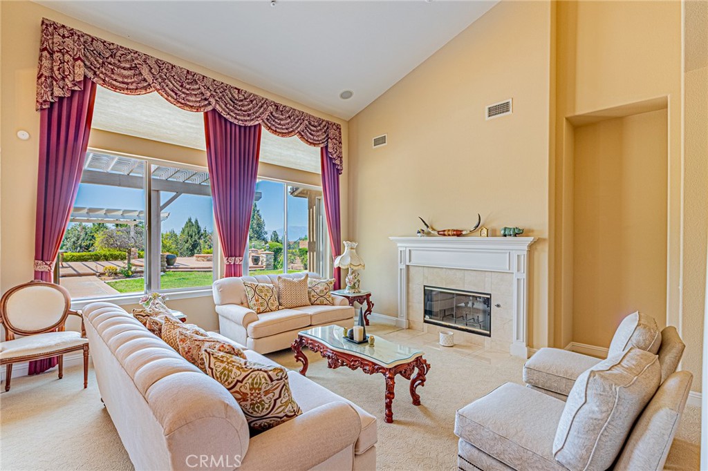 4088 Shady Ridge Circle Corona, CA 92881 - Photo 4 of 47 a living room with furniture fireplace and a large window