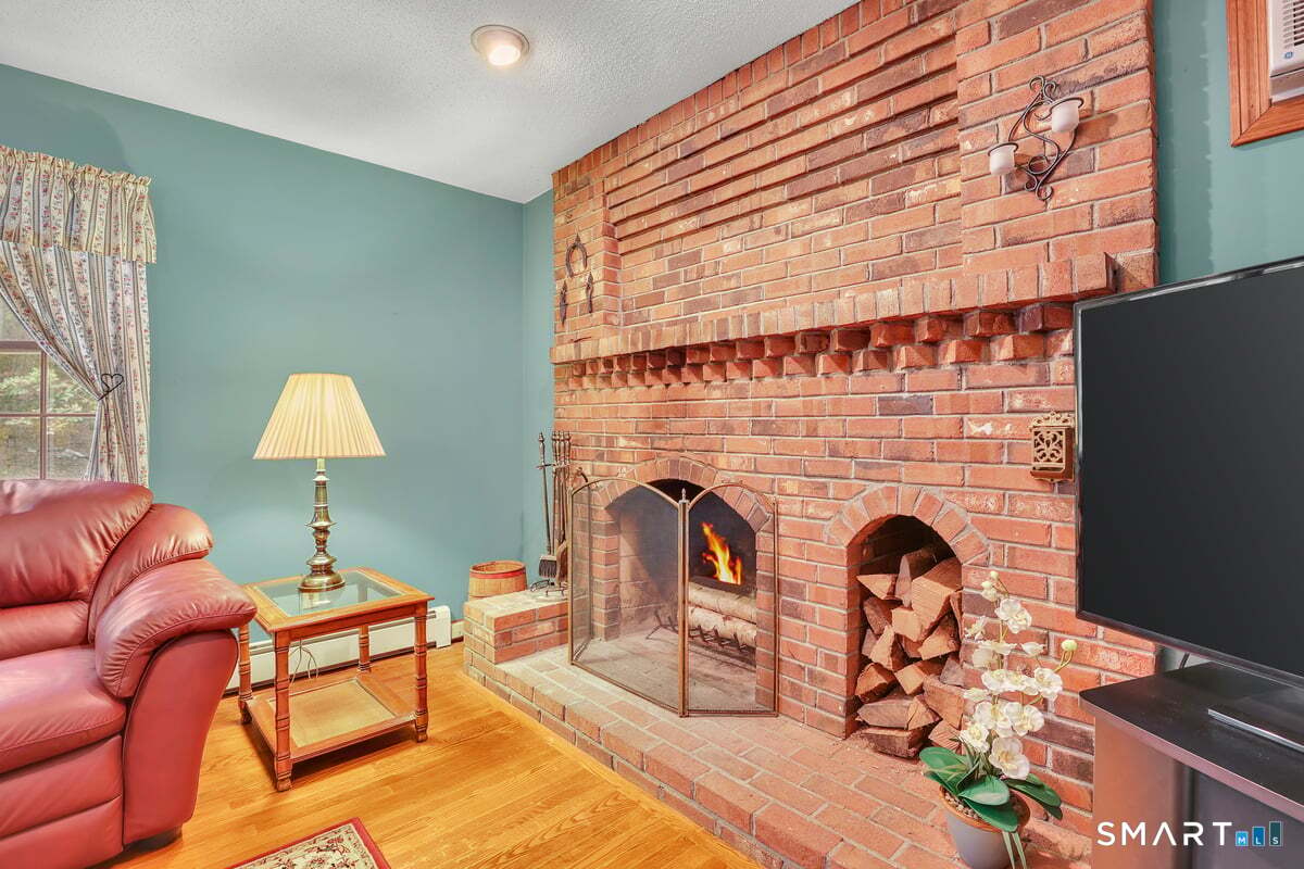78 Mountain Ridge Drive Coventry, CT 06238 - Photo 15 of 39 The wood burning fireplace is the focal point of the family room with so much detail and a space to hold the wood on those cold New England nights!
