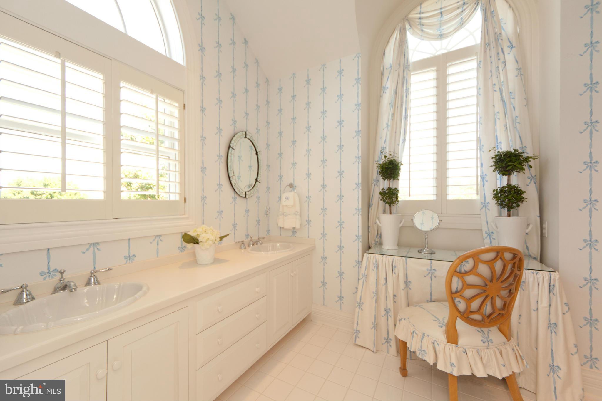 1234 Cherry Tree Lane Annapolis, MD 21403 - Photo 16 of 29 a spacious bathroom with sinks mirror and a bathtub next to a window