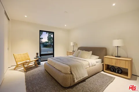 a bedroom with a bed and chair