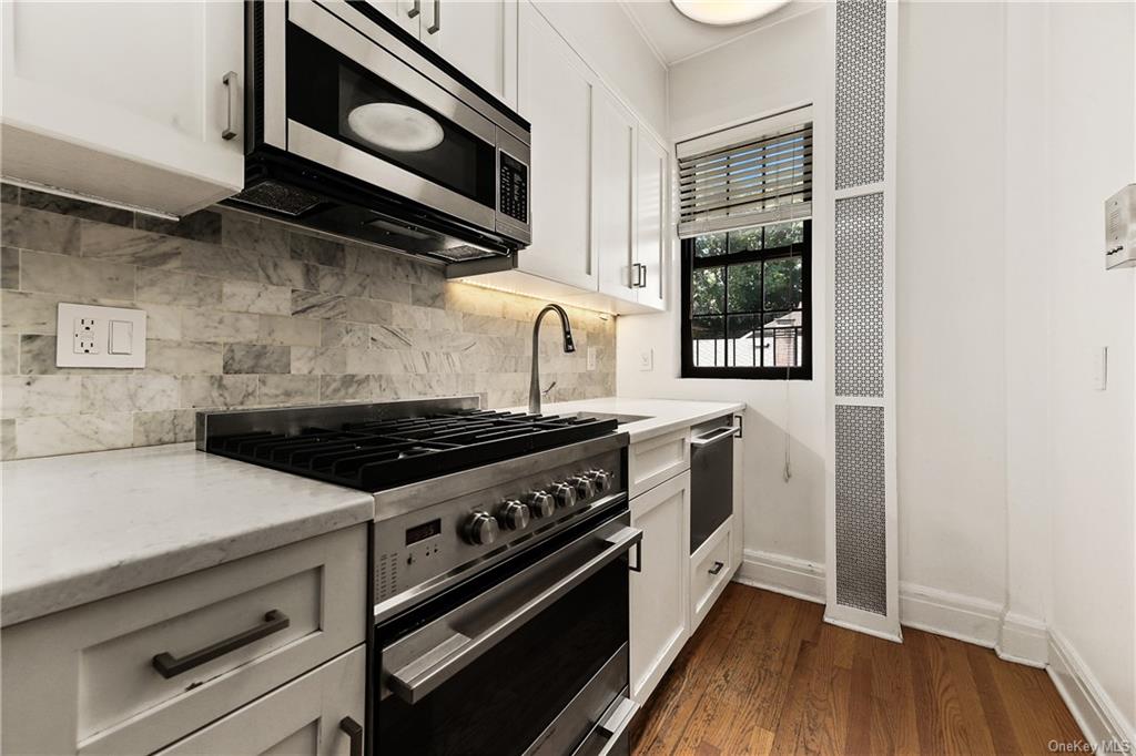 26 Pondfield Road, Unit 3C Bronxville, NY 10708 - Photo 3 of 15 Kitchen features stainless steel appliances and marble counter top.