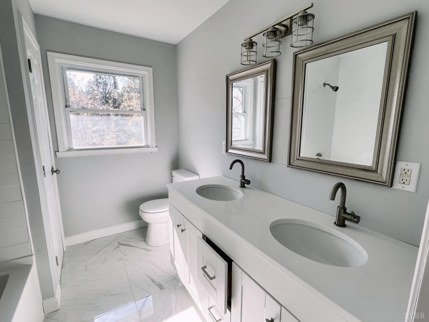 288 Lynbrook Road Rustburg, VA 24588 - Photo 11 of 34 a bathroom with 2 sink and a window