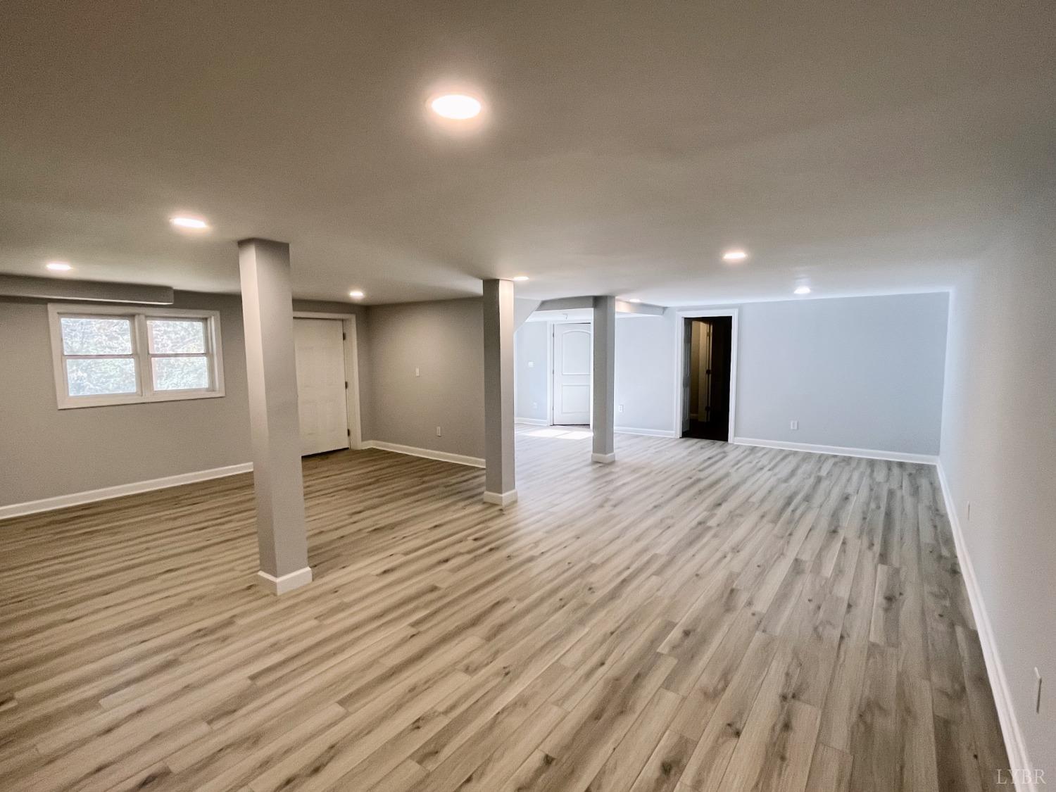 288 Lynbrook Road Rustburg, VA 24588 - Photo 20 of 34 a view of an empty room with wooden floor and a window