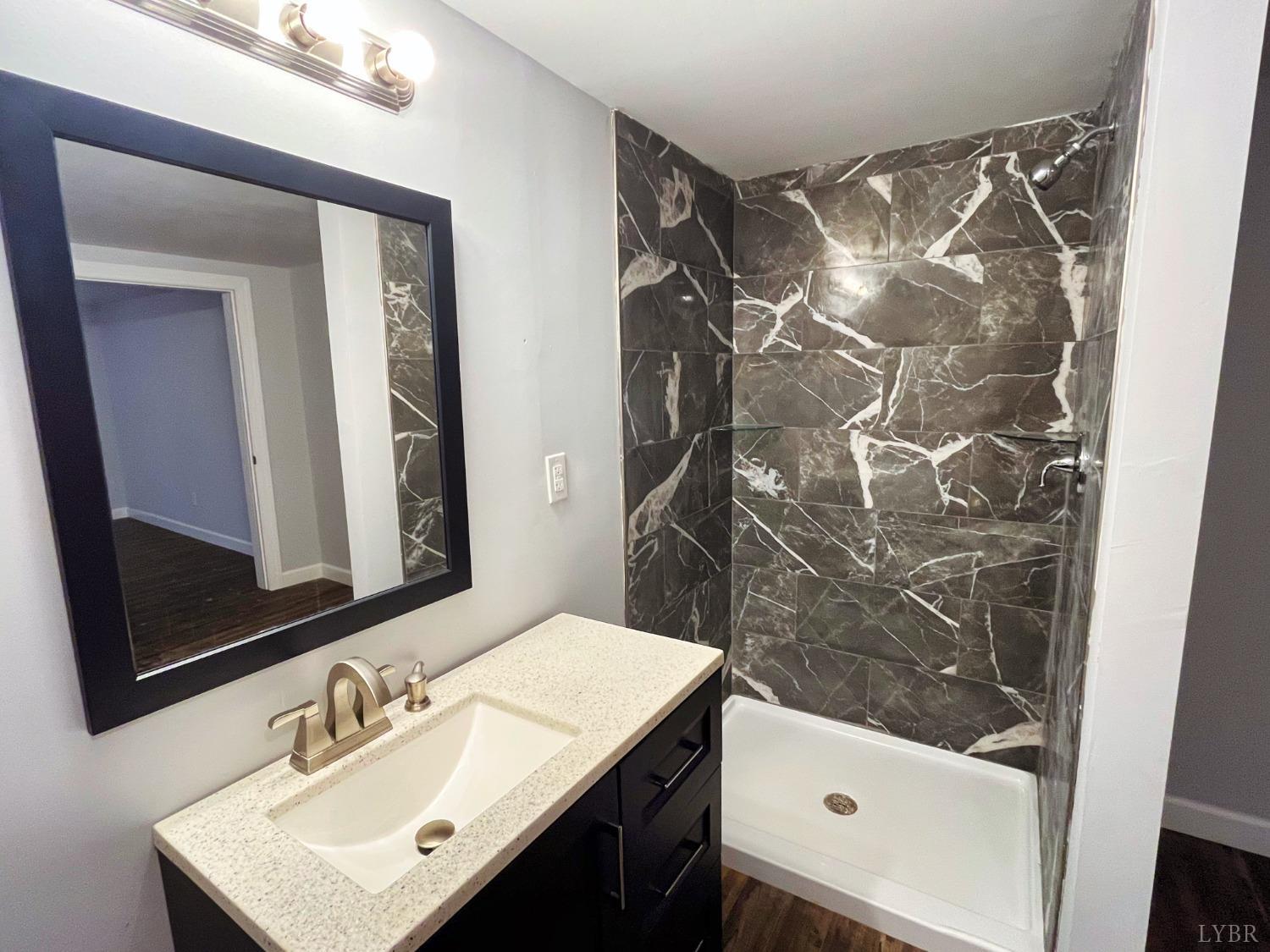 288 Lynbrook Road Rustburg, VA 24588 - Photo 25 of 34 a bathroom with a sink and a mirror