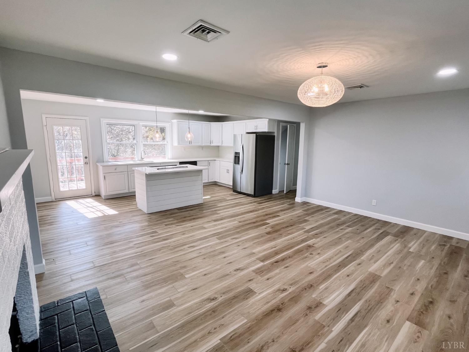 288 Lynbrook Road Rustburg, VA 24588 - Photo 4 of 34 a large kitchen with a wooden floor and stainless steel appliances