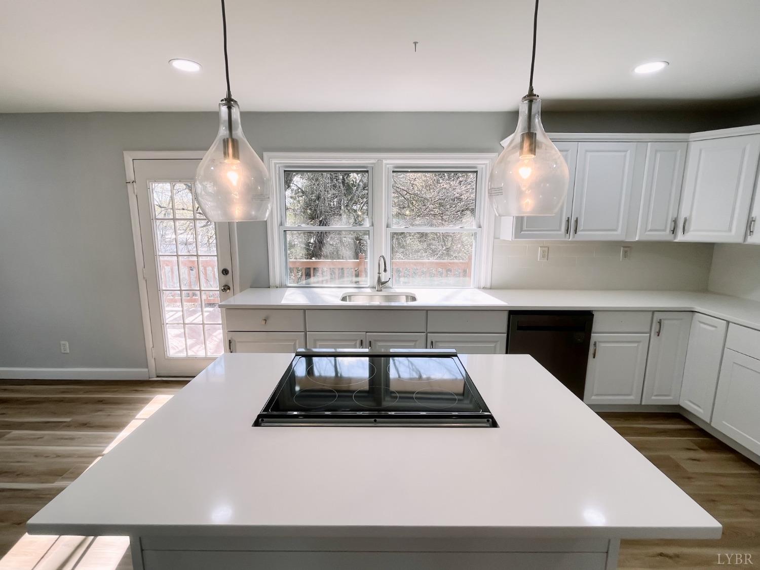 288 Lynbrook Road Rustburg, VA 24588 - Photo 5 of 34 a kitchen with a stove a sink a window and wooden floor