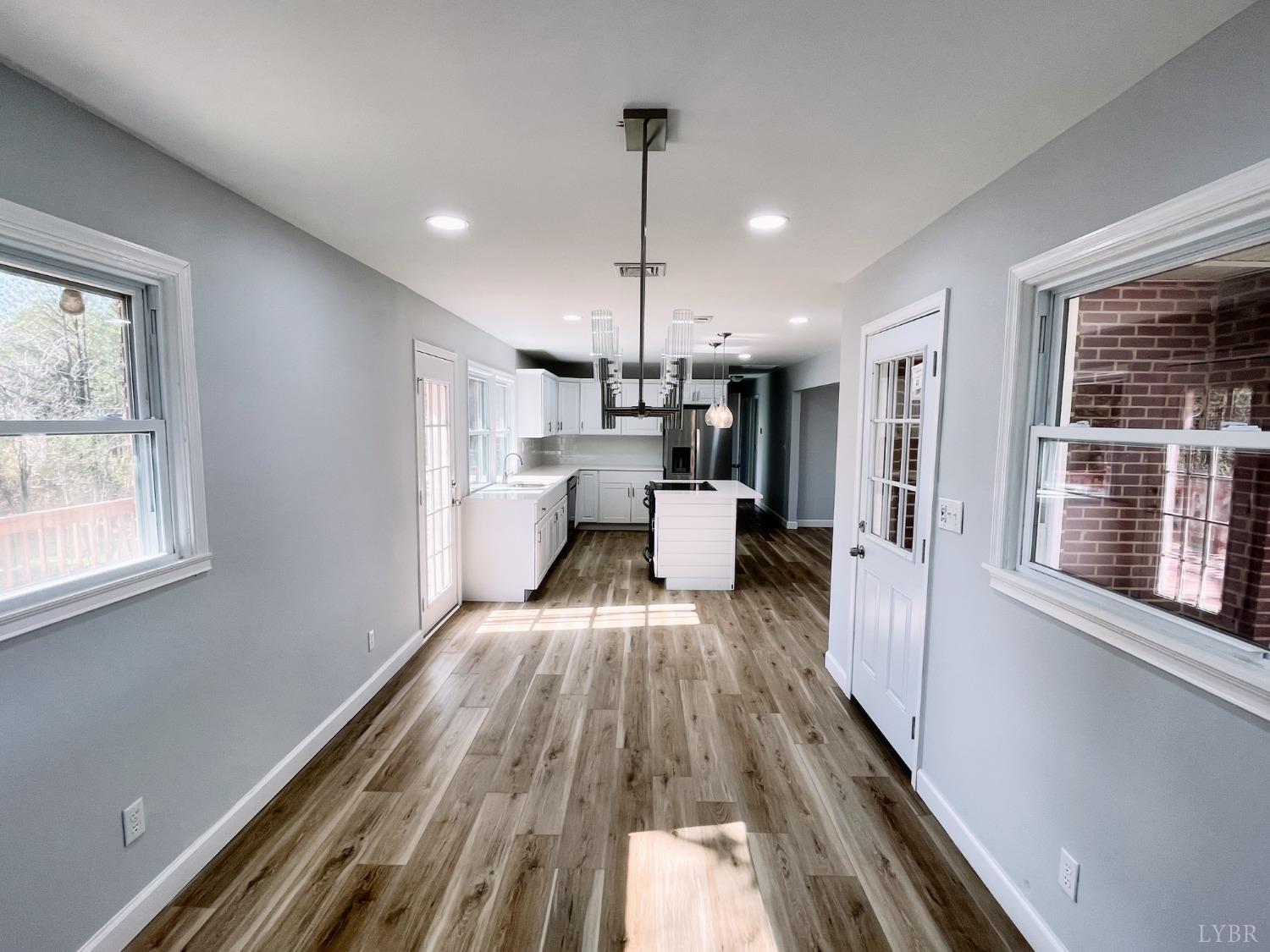 288 Lynbrook Road Rustburg, VA 24588 - Photo 8 of 34 a view of a kitchen with wooden floor and a window