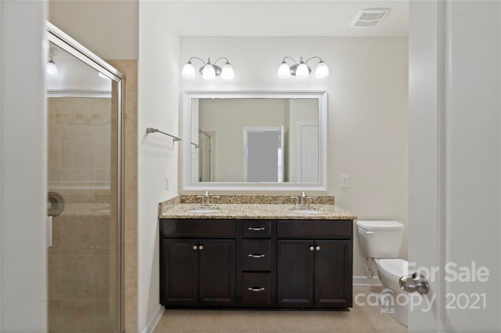 4331 Oxford Mill Road Waxhaw, NC 28173 - Photo 20 of 48 a bathroom with a granite countertop sink a toilet and a mirror