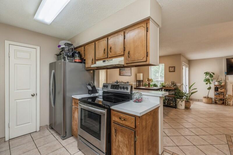 422 John King Road Crestview, FL 32539 - Photo 11 of 30 a kitchen with a stove and a refrigerator