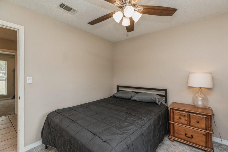 422 John King Road Crestview, FL 32539 - Photo 16 of 30 a bedroom with a bed and a lamp on a dresser