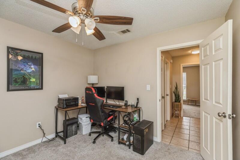 422 John King Road Crestview, FL 32539 - Photo 17 of 30 a view of a workspace with furniture and a ceiling fan