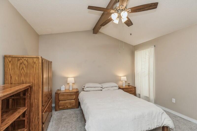 422 John King Road Crestview, FL 32539 - Photo 20 of 30 a bedroom with a bed and a chandelier