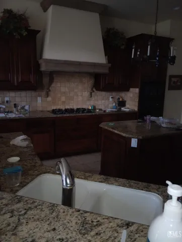 a kitchen with a sink and a stove