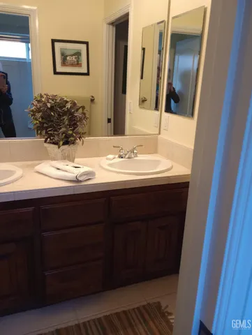 a bathroom with a sink vanity and a mirror