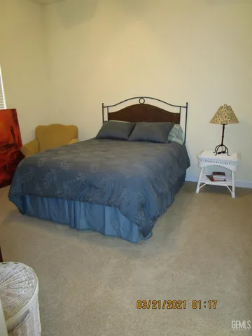 a bedroom with a bed and chair