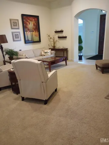 a living room with furniture and a mirror