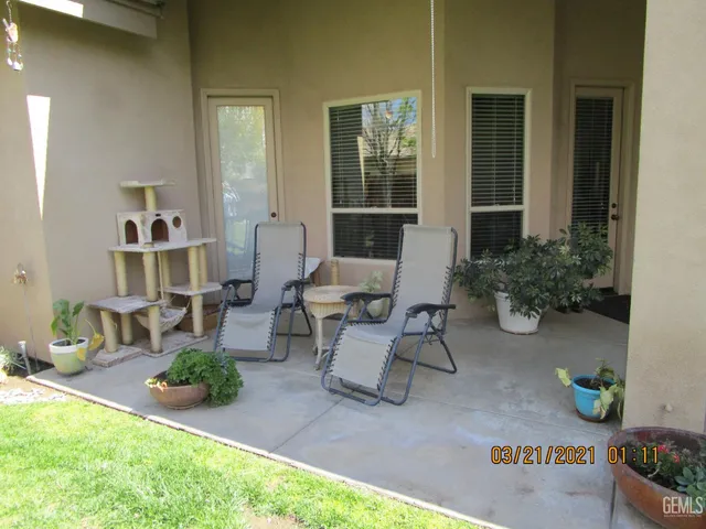 a view of a house with backyard sitting area and garden