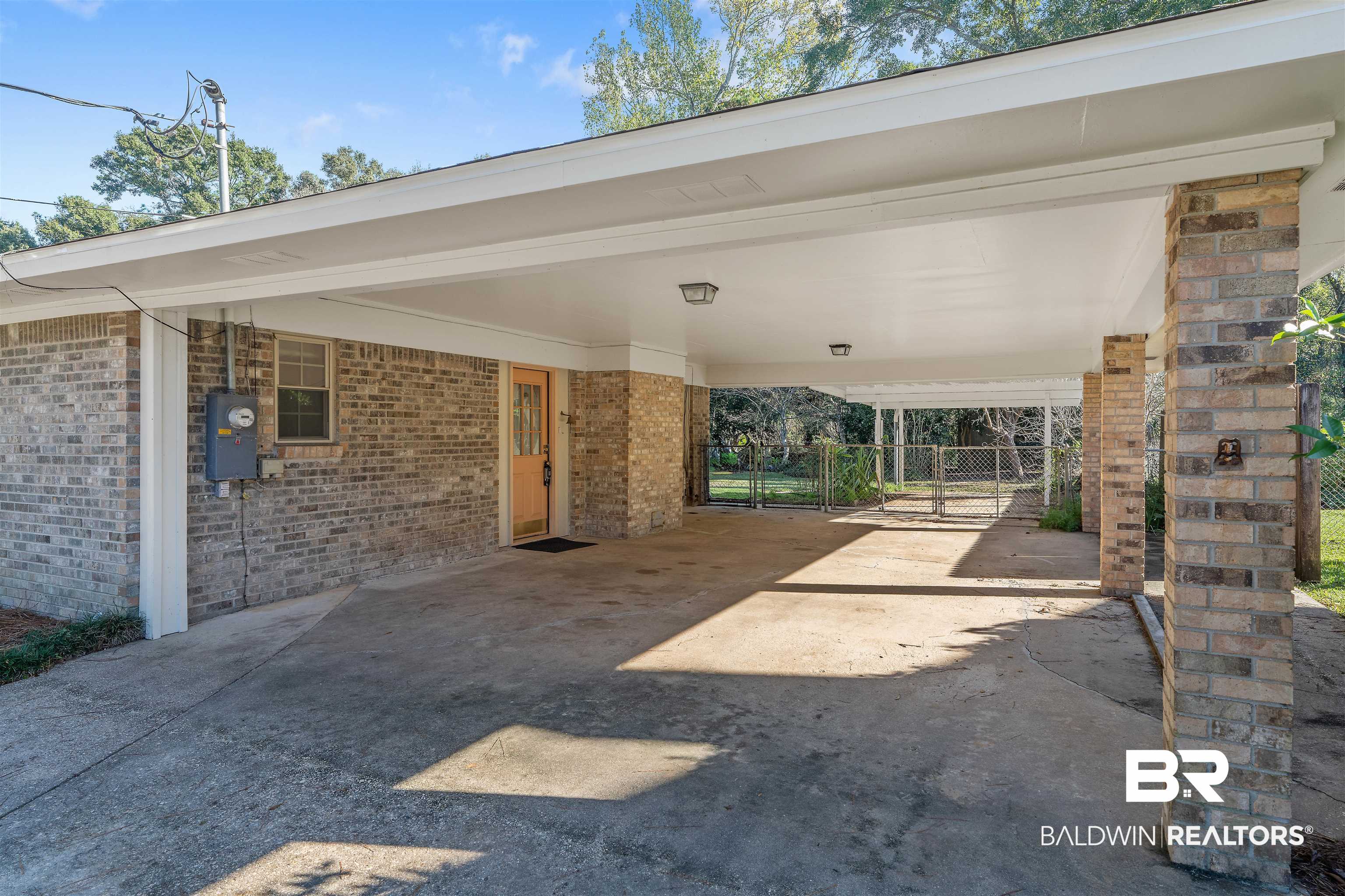 621 Spanish Main Spanish Fort, AL 36527 - Photo 6 of 29 View of parking / parking lot with a carport