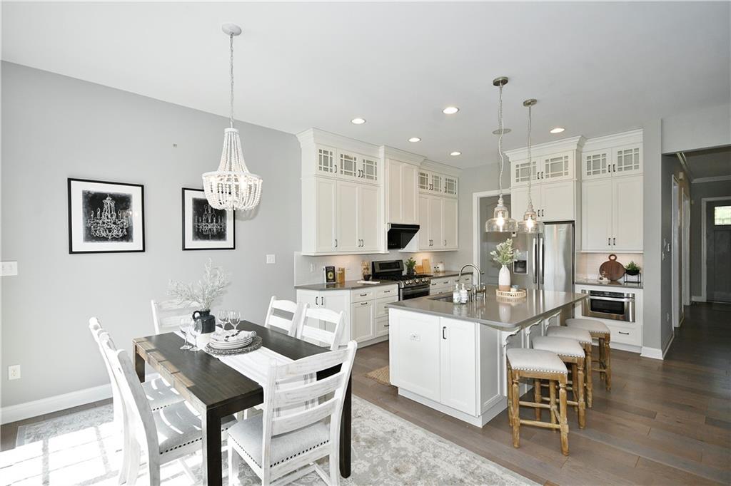 239 Venango Trail Mars, PA 16046 - Photo 14 of 39 a kitchen with stainless steel appliances kitchen island granite countertop a dining table chairs and white cabinets