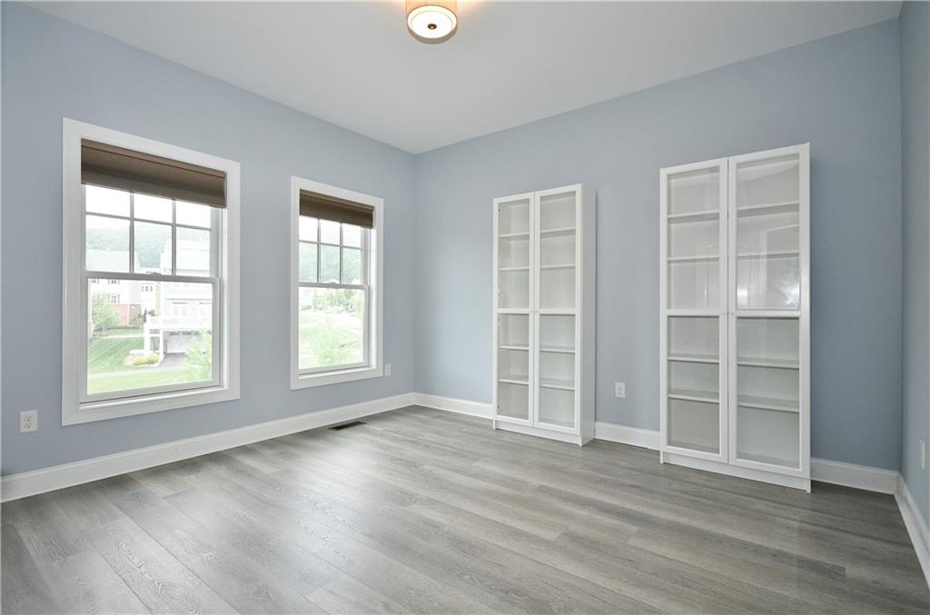 239 Venango Trail Mars, PA 16046 - Photo 28 of 39 an empty room with wooden floor and windows