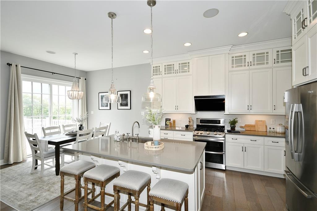 239 Venango Trail Mars, PA 16046 - Photo 7 of 39 a kitchen with kitchen island granite countertop a sink counter and chairs