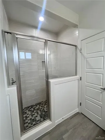 a bathroom with a glass shower door
