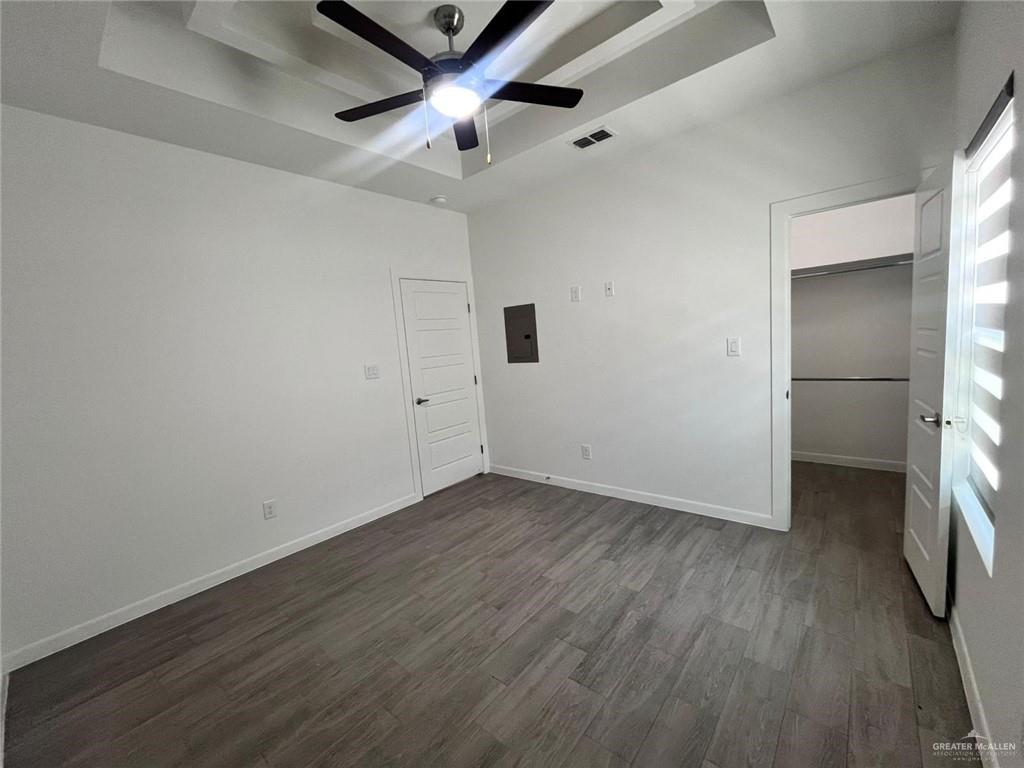3900 Ventura Avenue, Unit 1 Edinburg, TX 78541 - Photo 7 of 14 an empty room with wooden floor and a ceiling fan