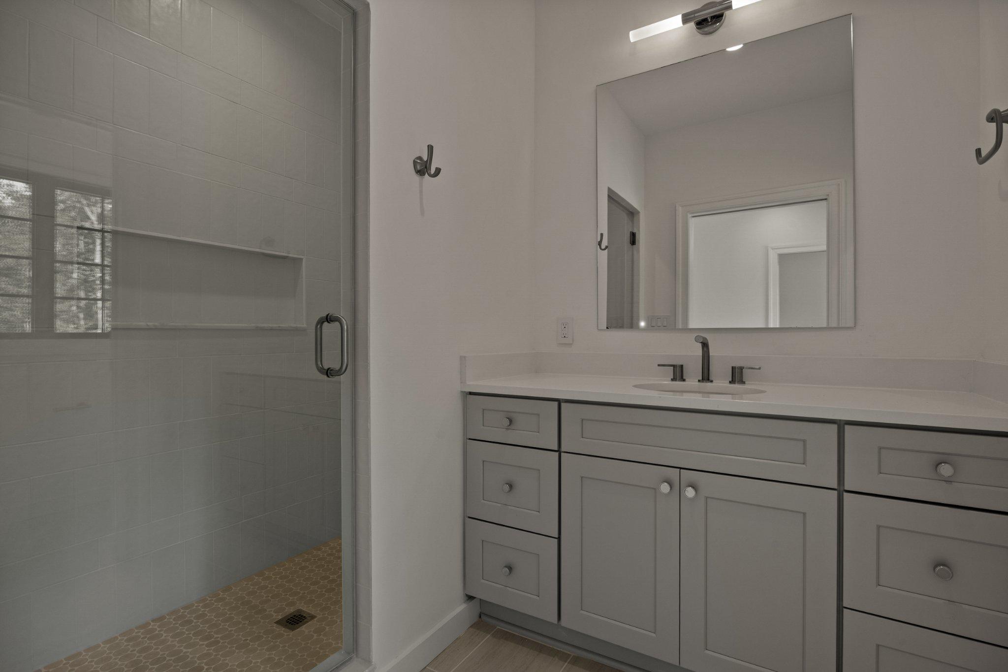 8634 Overlook Road McLean, VA 22102 - Photo 82 of 88 a bathroom with a shower sink and mirror