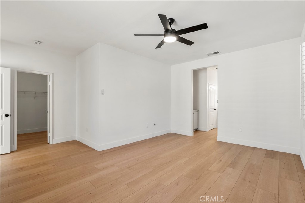 256 4 Seasons Boulevard Hemet, CA 92545 - Photo 11 of 31 a view of a big room with wooden floor and a ceiling fan