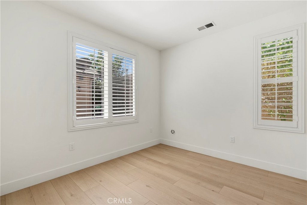 256 4 Seasons Boulevard Hemet, CA 92545 - Photo 14 of 31 a view of an empty room with wooden floor and a window