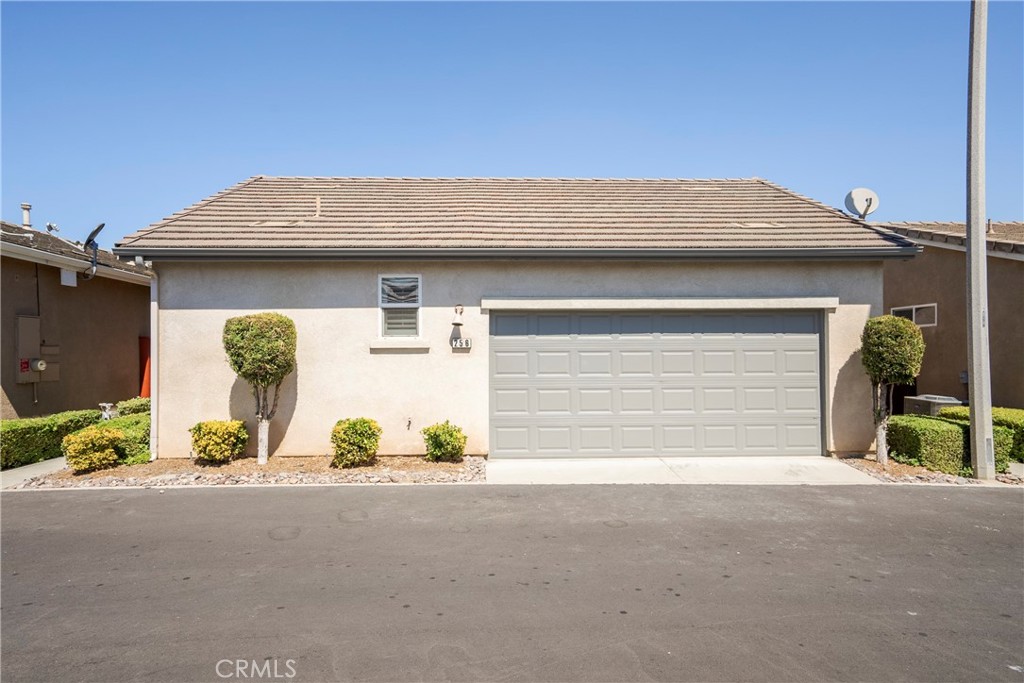 256 4 Seasons Boulevard Hemet, CA 92545 - Photo 21 of 31 a front view of a house with a yard and garage