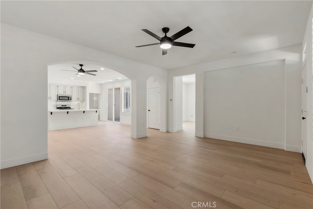 256 4 Seasons Boulevard Hemet, CA 92545 - Photo 4 of 31 a view of a livingroom with wooden floor and a ceiling fan