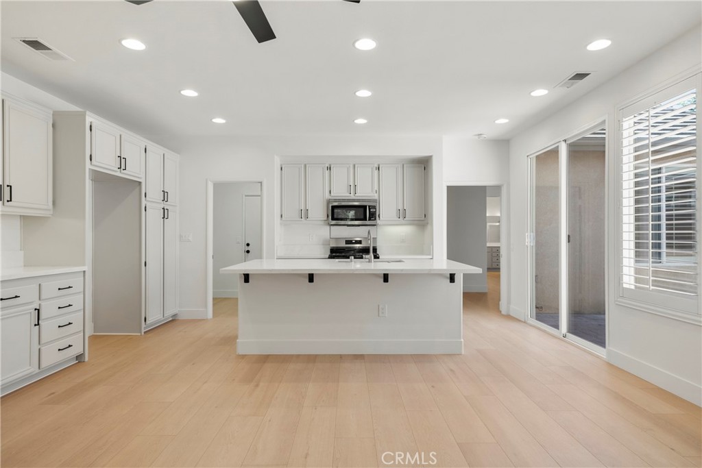 256 4 Seasons Boulevard Hemet, CA 92545 - Photo 5 of 31 a view of kitchen with stainless steel appliances kitchen island granite countertop a refrigerator and cabinets