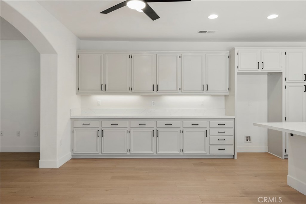 256 4 Seasons Boulevard Hemet, CA 92545 - Photo 7 of 31 a kitchen with granite countertop white cabinets and white stainless steel appliances