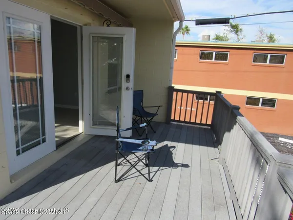 a balcony with table and chairs