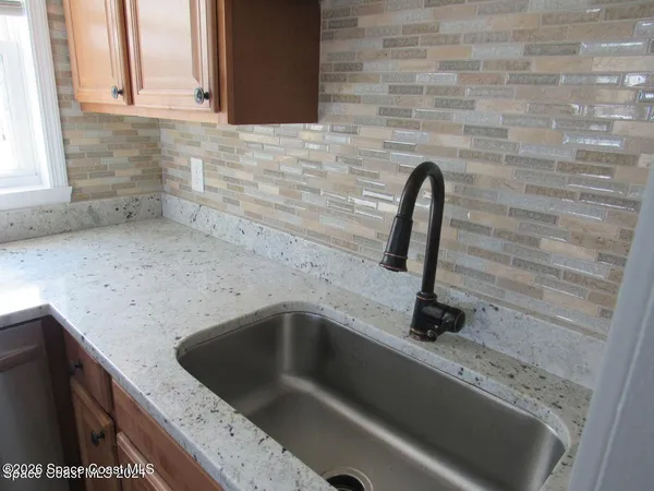 a kitchen with a stove microwave and sink