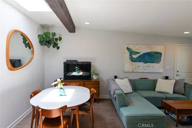 a living room with furniture and a mirror