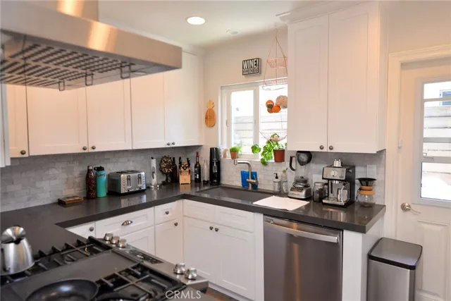 a kitchen with a sink stove and cabinets