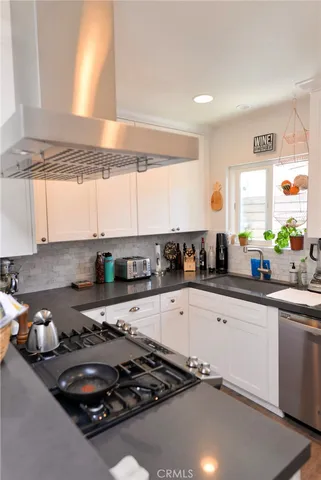 a kitchen with a sink a stove and cabinets