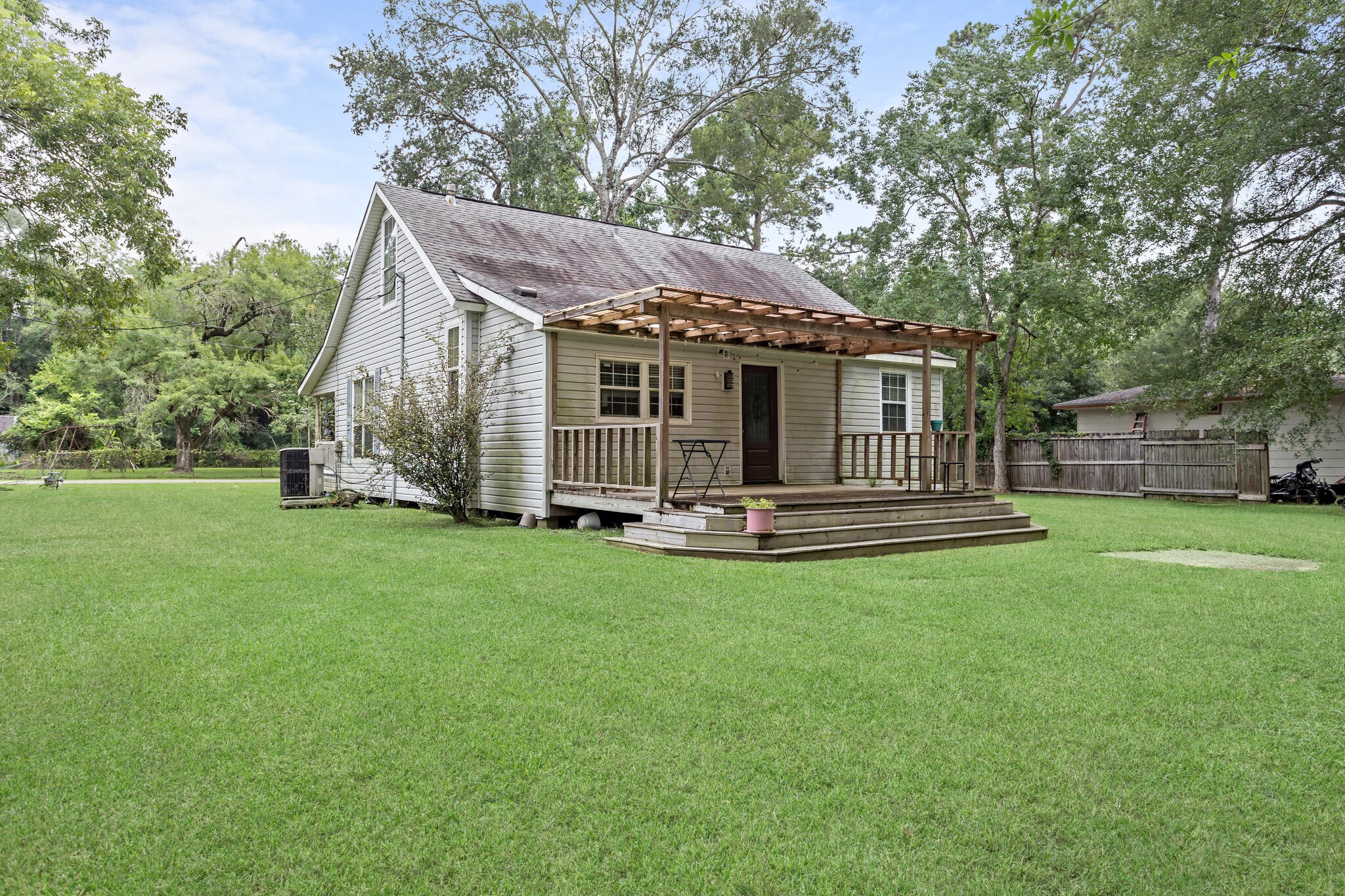 7230 Bythewood Road Beaumont, TX 77713 - Photo 35 of 35 a view of a house with a backyard and a tree