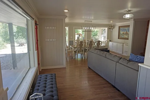 a hallway with wooden floor and furniture