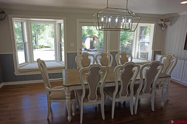a view of a dining room with furniture window and wooden floor