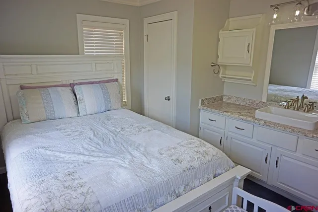 a bedroom with a bed and a dresser